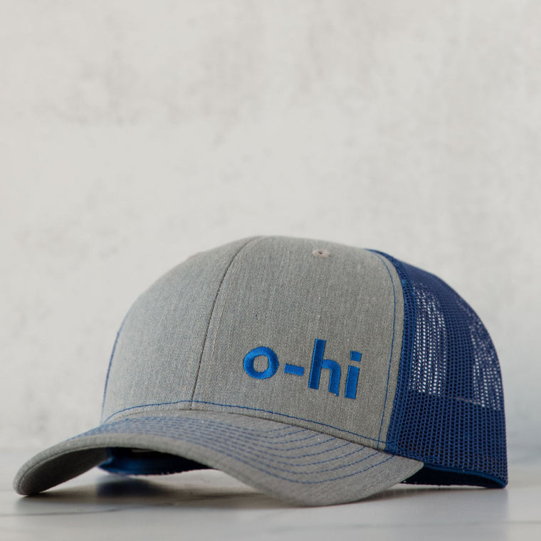 A hat with a gray crown and blue mesh back, featuring the text 'o-hi' on the front.