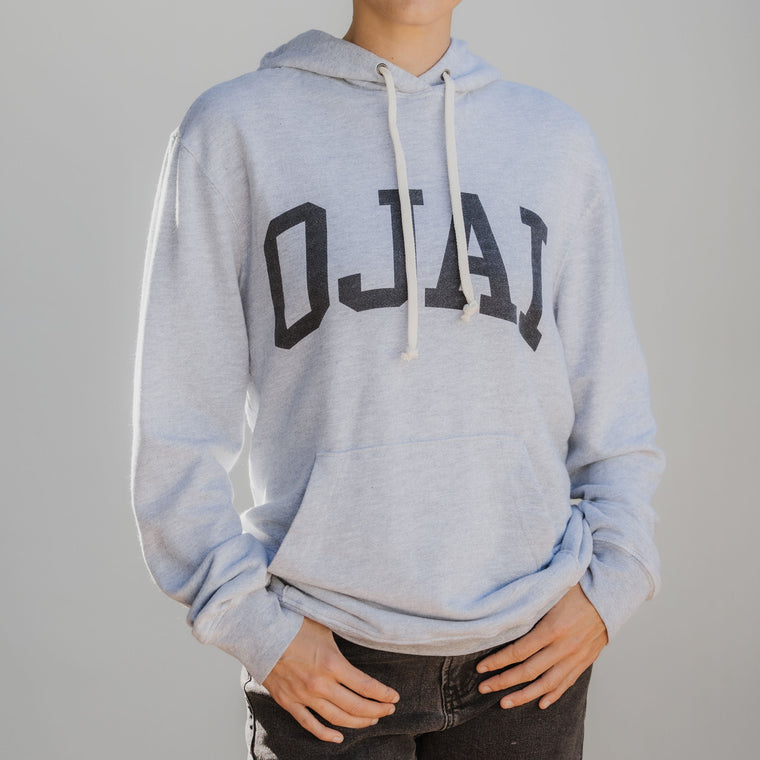 Person wearing gray hoodie with Ojai letters on front