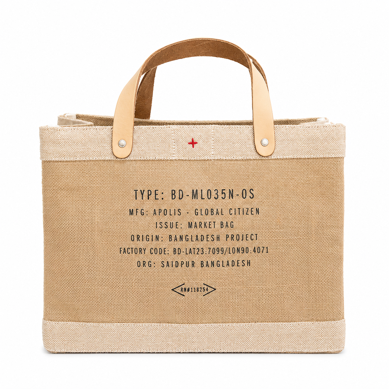A canvas tote bag in beige and cream with light tan leather handles, featuring black printed text and a small red cross symbol on the front, set against a plain white background.