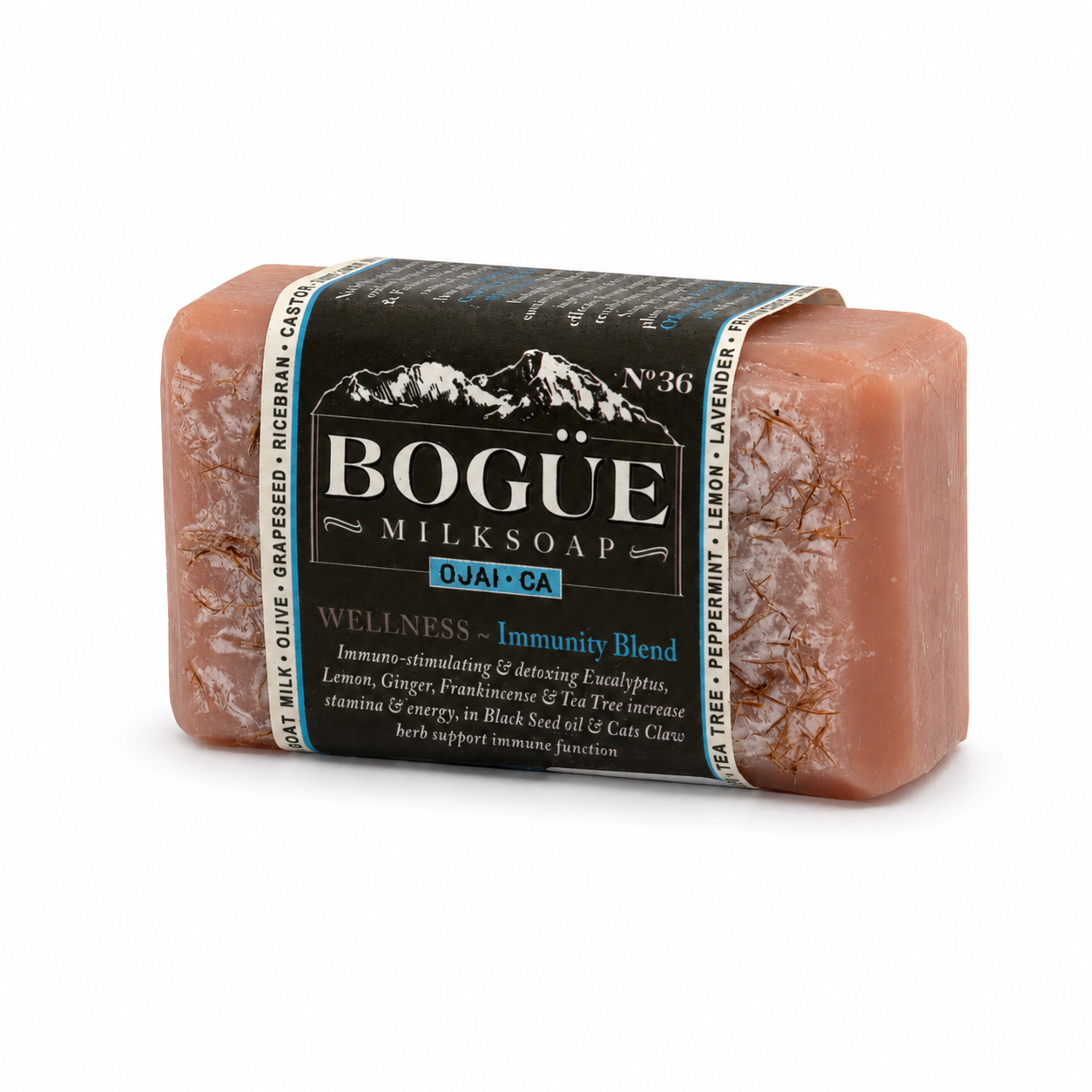 A rectangular bar of Bogue Milksoap with a dark paper label, photographed on a clean white background. The soap has a dusty rose-brown color with visible botanical flecks, and the label features a black top with white text and a blue accent bar.