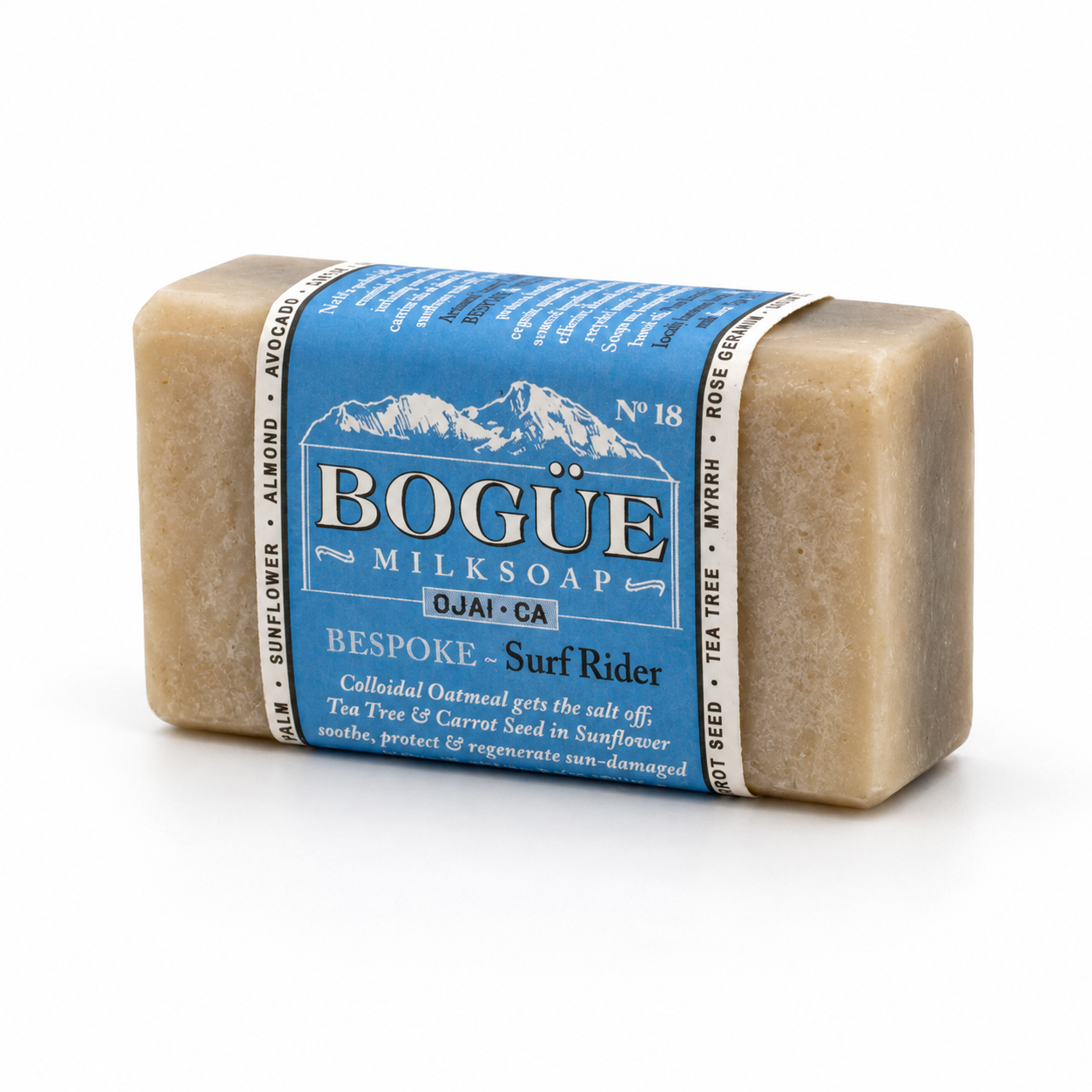 A rectangular bar of BOGÜE Milksoap labeled 'Bespoke - Surf Rider' in natural beige soap with a blue paper label, photographed on a clean white background.