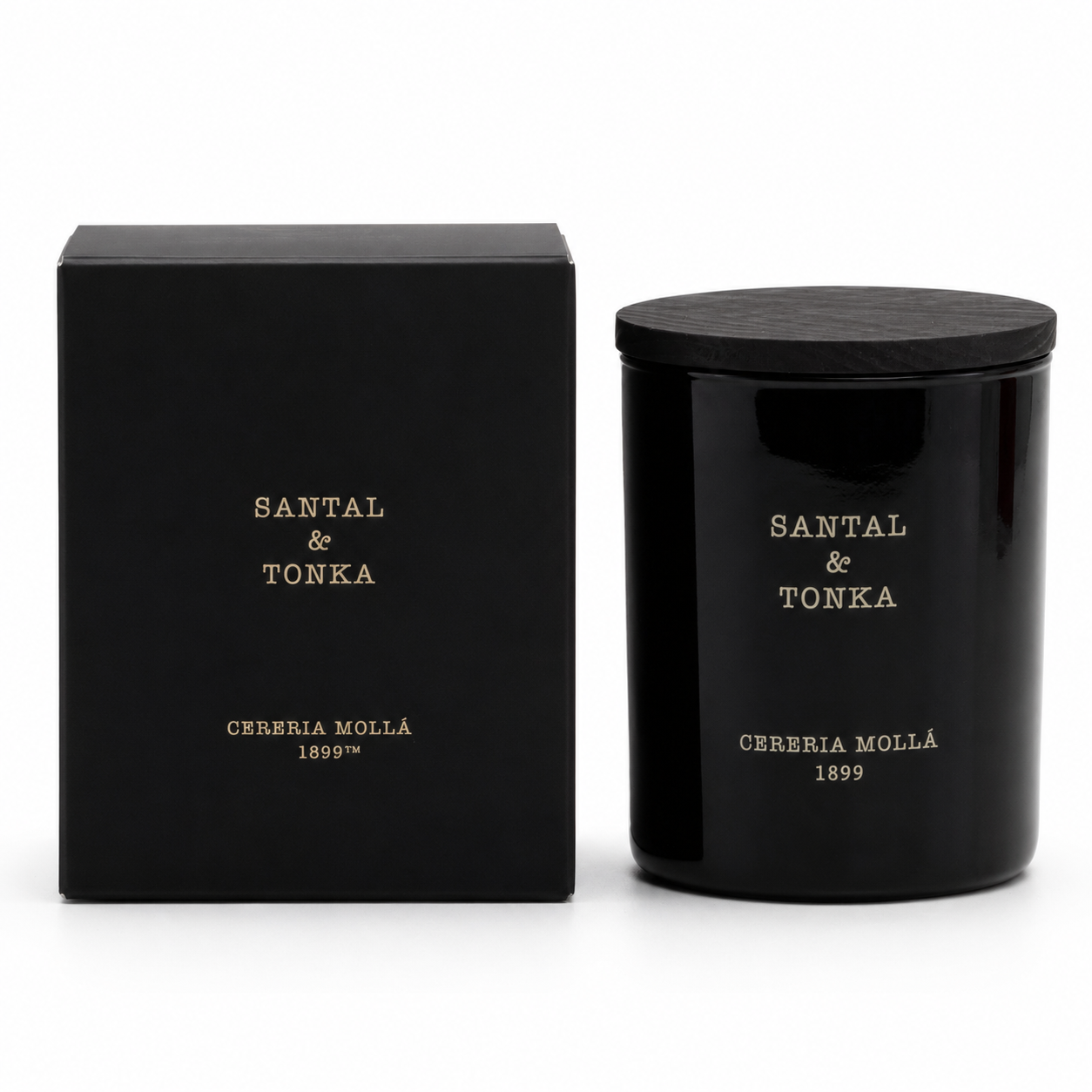 A black scented candle jar with a matching black lid stands next to its black packaging box. Both pieces feature gold lettering that reads 'SANTAL & TONKA' and 'CERERIA MOLLÁ 1899'.