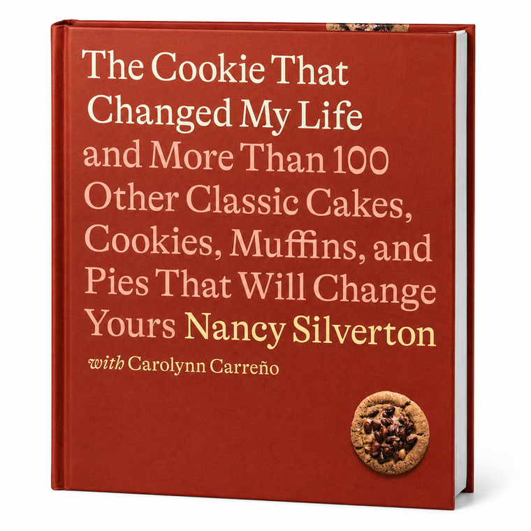 The Cookie That Changed My Life hardcover cookbook by Nancy Silverton, featuring a textured dark red cover with cream and gold text, and a chocolate chip cookie illustration in the bottom right corner.