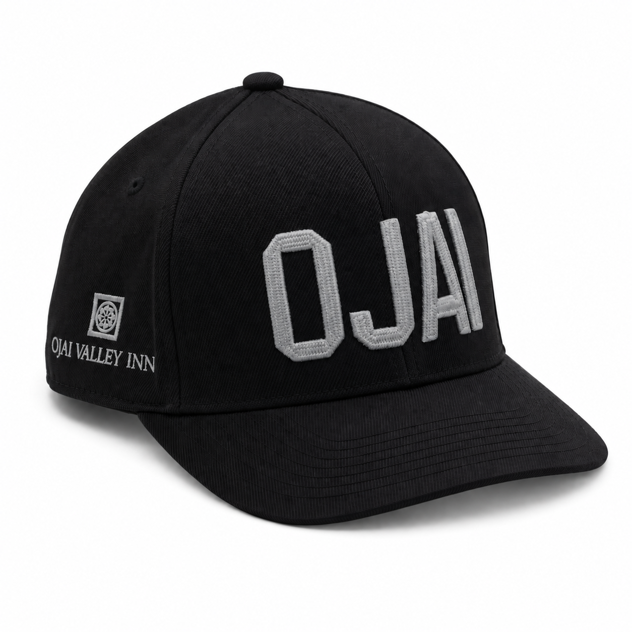 A black baseball cap featuring large gray embroidered 'OJAI' lettering on the front and 'OJAI VALLEY INN' with a logo on the side, set against a plain white background.