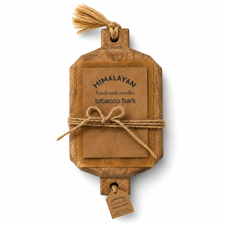 A rectangular wooden box with rounded corners and a hanging loop, wrapped in natural twine with a brown paper label reading 'HIMALAYAN handmade scented tobacco bark.' A small matching tag hangs from the bottom loop.
