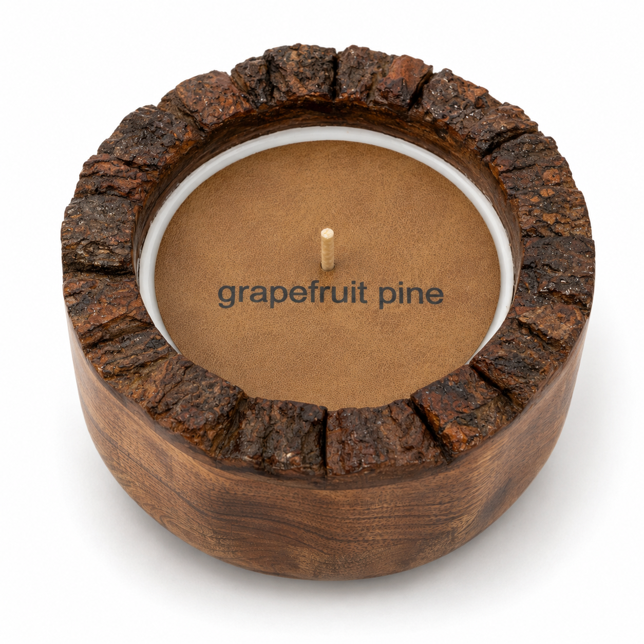 A rustic wooden candle holder with a bark-textured rim and a single wick, filled with a brown wax insert. The words 'grapefruit pine' are printed on the front, and the item is photographed on a clean white background.