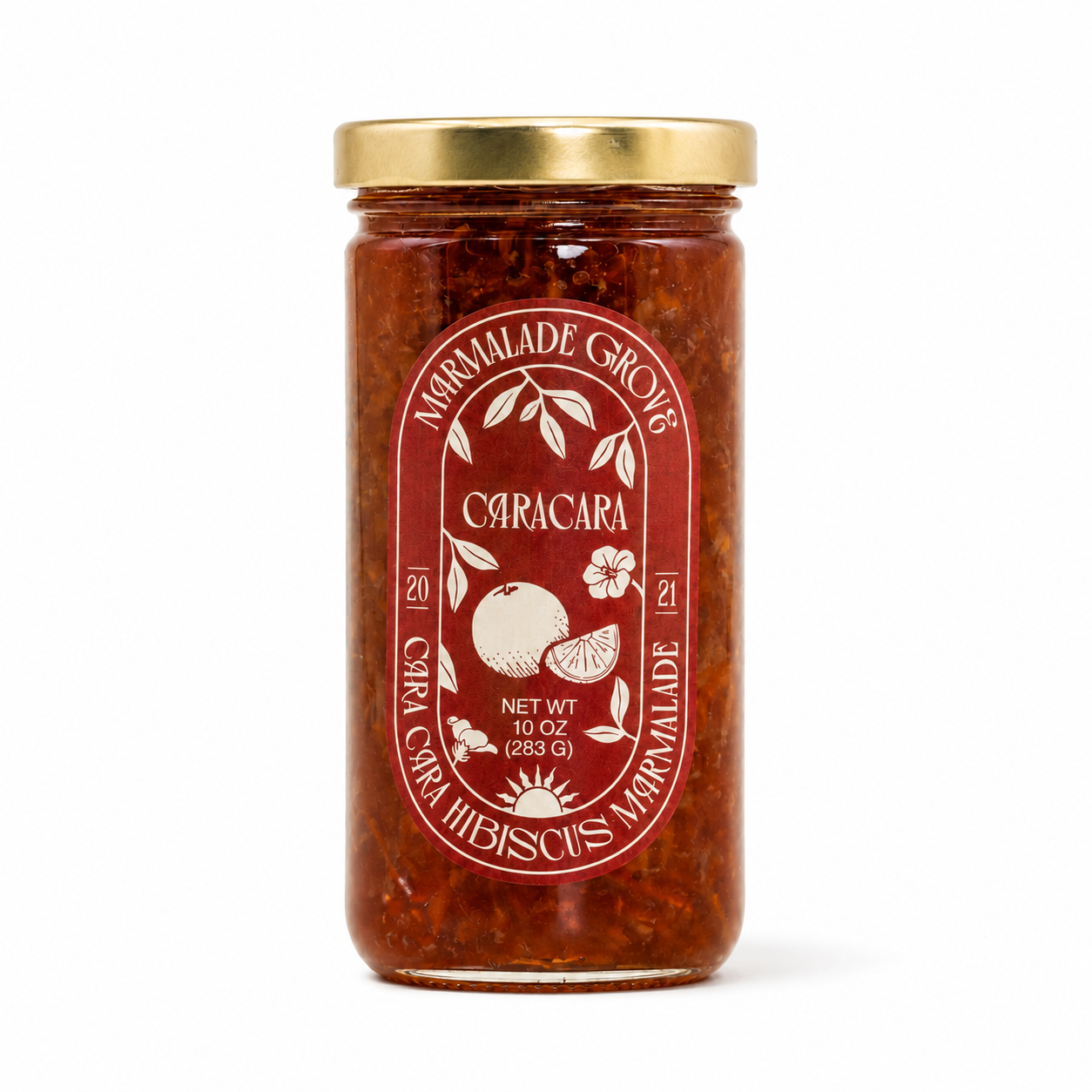 A glass jar of Marmalade Grove Caracara citrus marmalade with a gold metal lid and a red label, set against a plain white background.