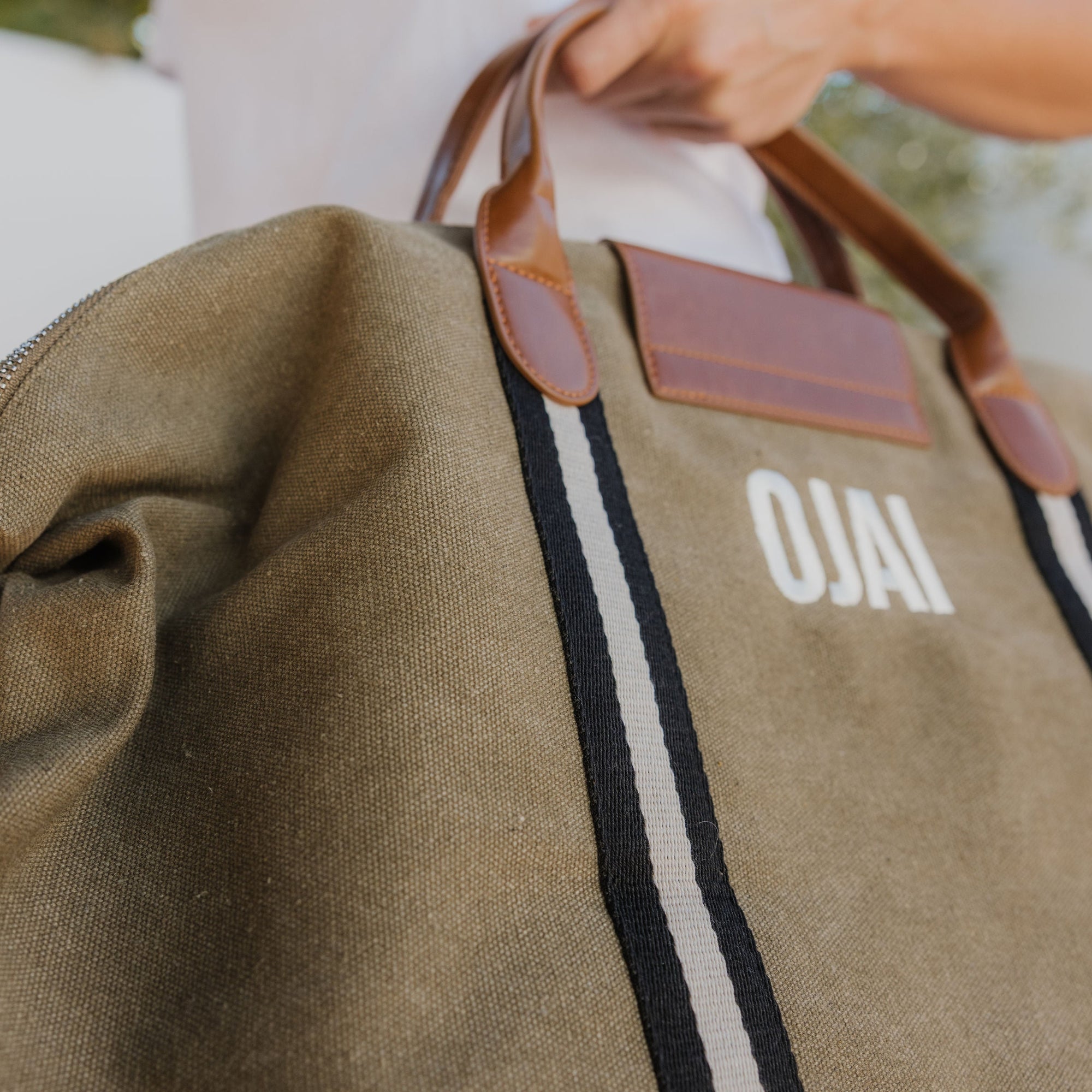 Brown bag with 'OJAI' branding on a blurred background