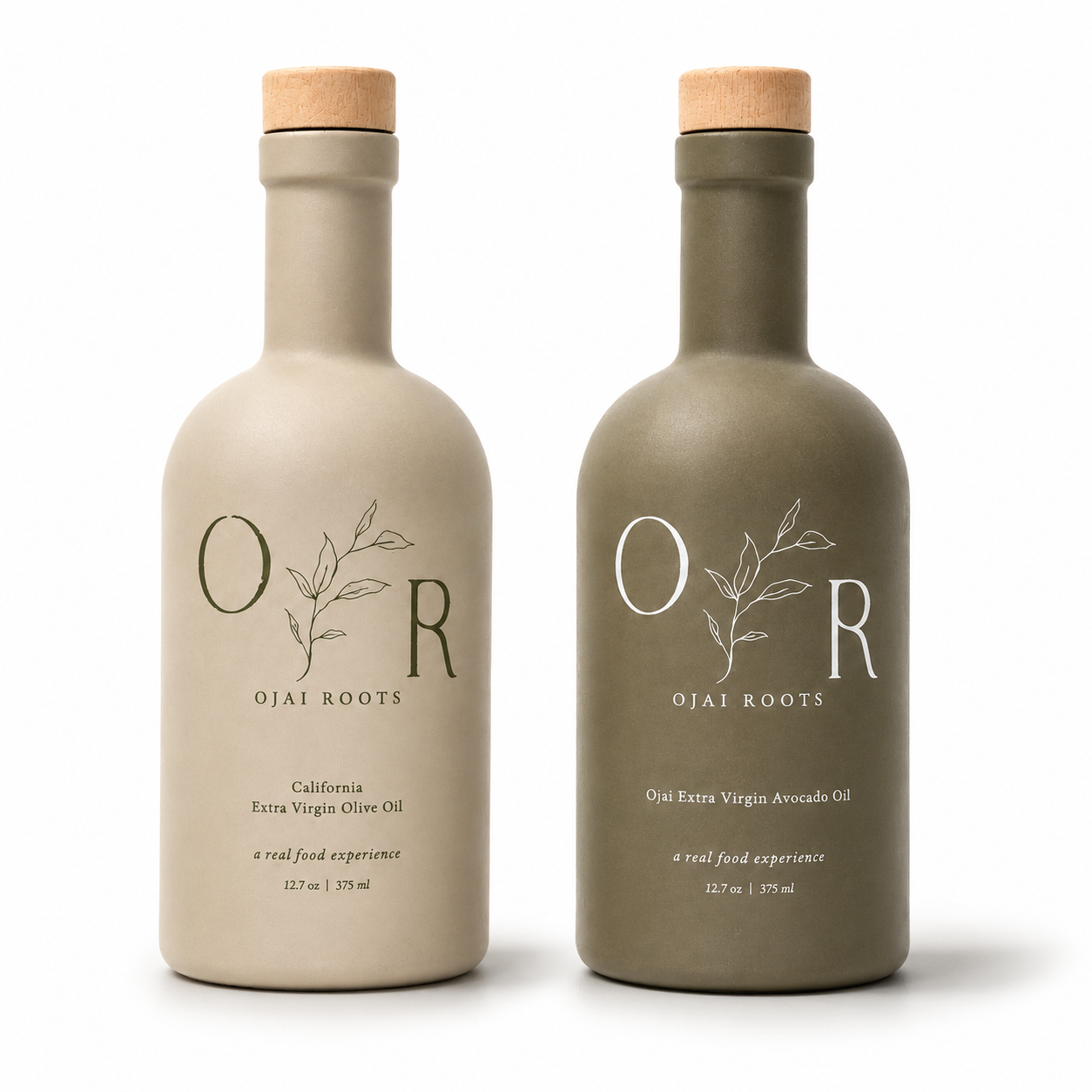 Two matte ceramic bottles of Ojai Roots olive oils on a white background. The left bottle is a light warm beige for California Extra Virgin Olive Oil, and the right bottle is a muted sage green for Ojai Extra Virgin Avocado Oil.