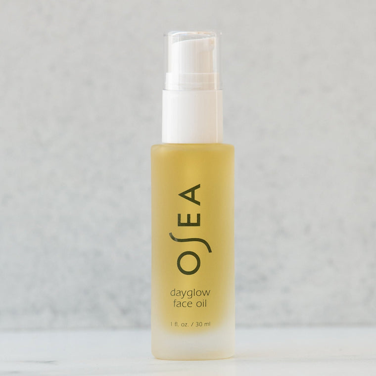 A pump bottle of OSEA Dayglow Face Oil against a neutral background.