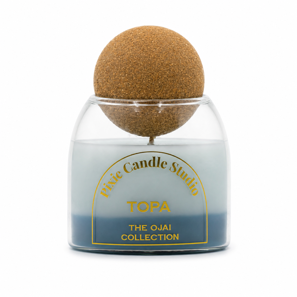 A glass jar candle with a blue-to-light-gray gradient wax, topped with a large brown cork sphere. The front label reads 'Vivie Candle Studio TOPA THE OJAI COLLECTION'.