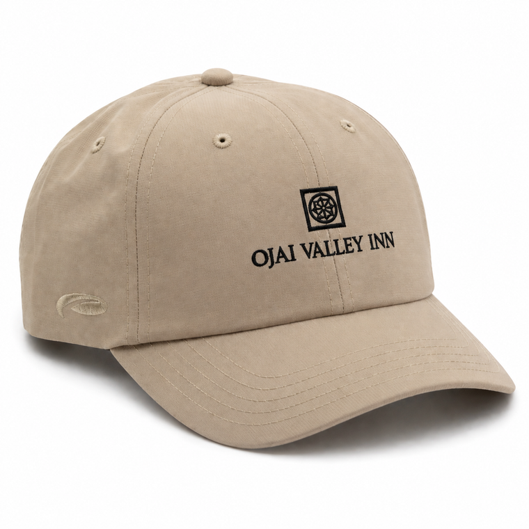 A beige baseball cap with black embroidered text reading 'OJAI VALLEY INN' and a small square logo on the front, shown on a clean white background.