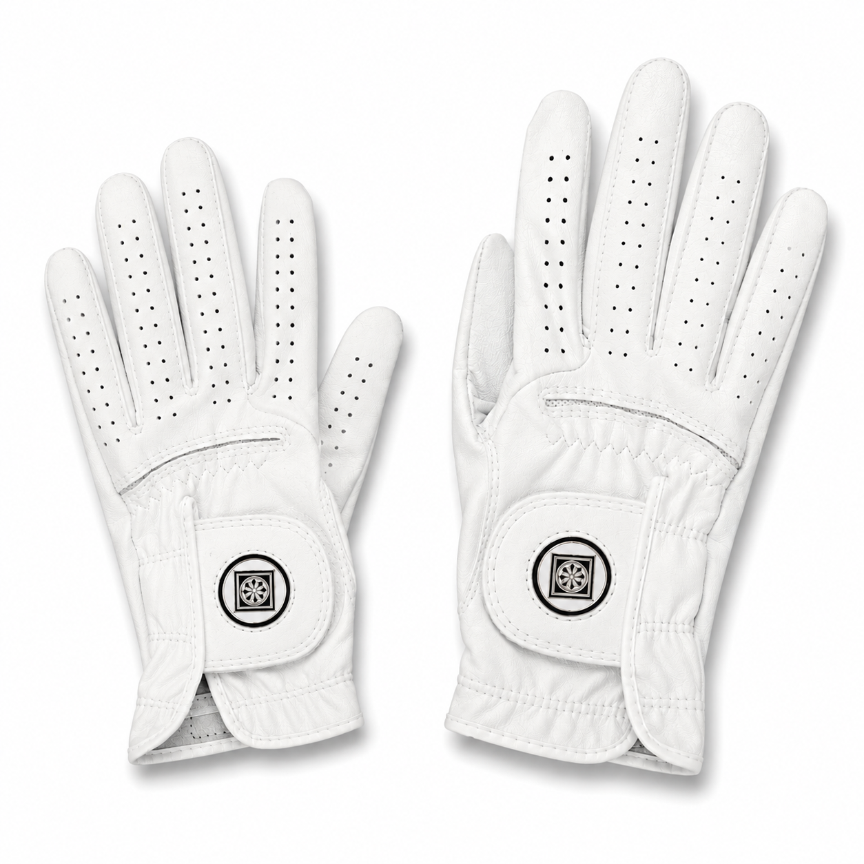 A pair of white golf gloves shown against a plain white background, one glove displaying the back of the hand with perforated finger sections and the other showing the back of the wrist with a circular logo patch.