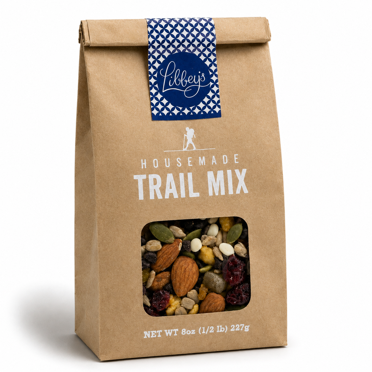 A 8 oz bag of Libbey's Housemade Trail Mix in a brown kraft paper bag with a blue patterned ribbon seal and a clear window showing the mixed nuts and dried fruit inside, on a white background.