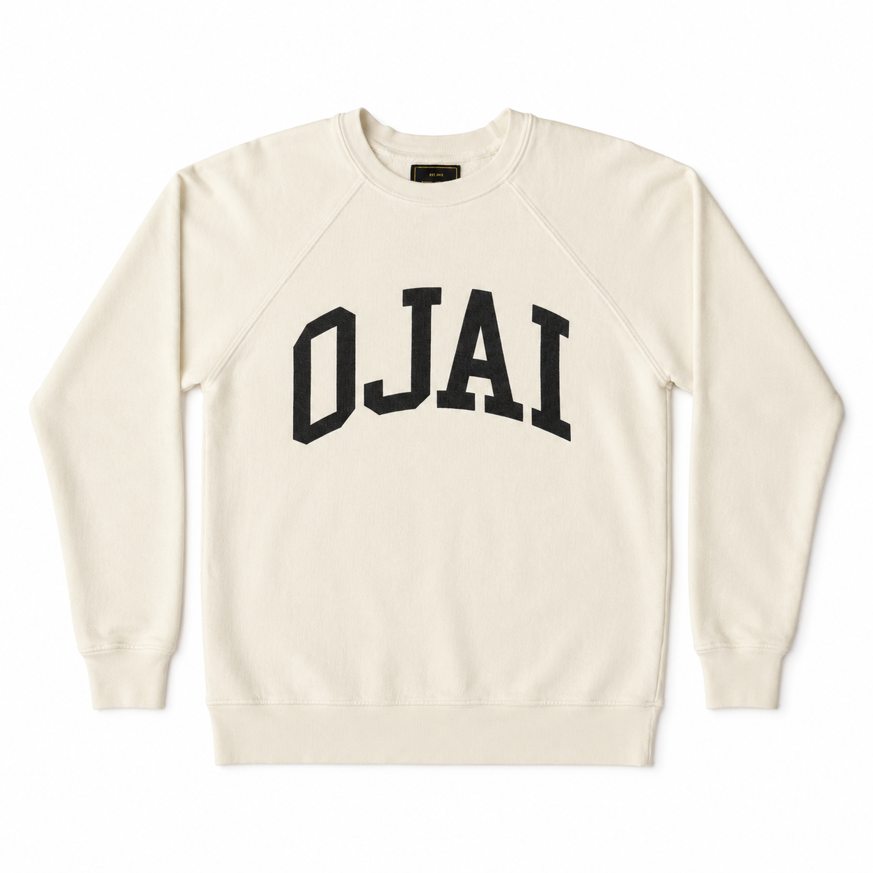 An off-white crewneck sweatshirt with 'OJAI' printed in black arched varsity letters across the chest, displayed flat against a white background.